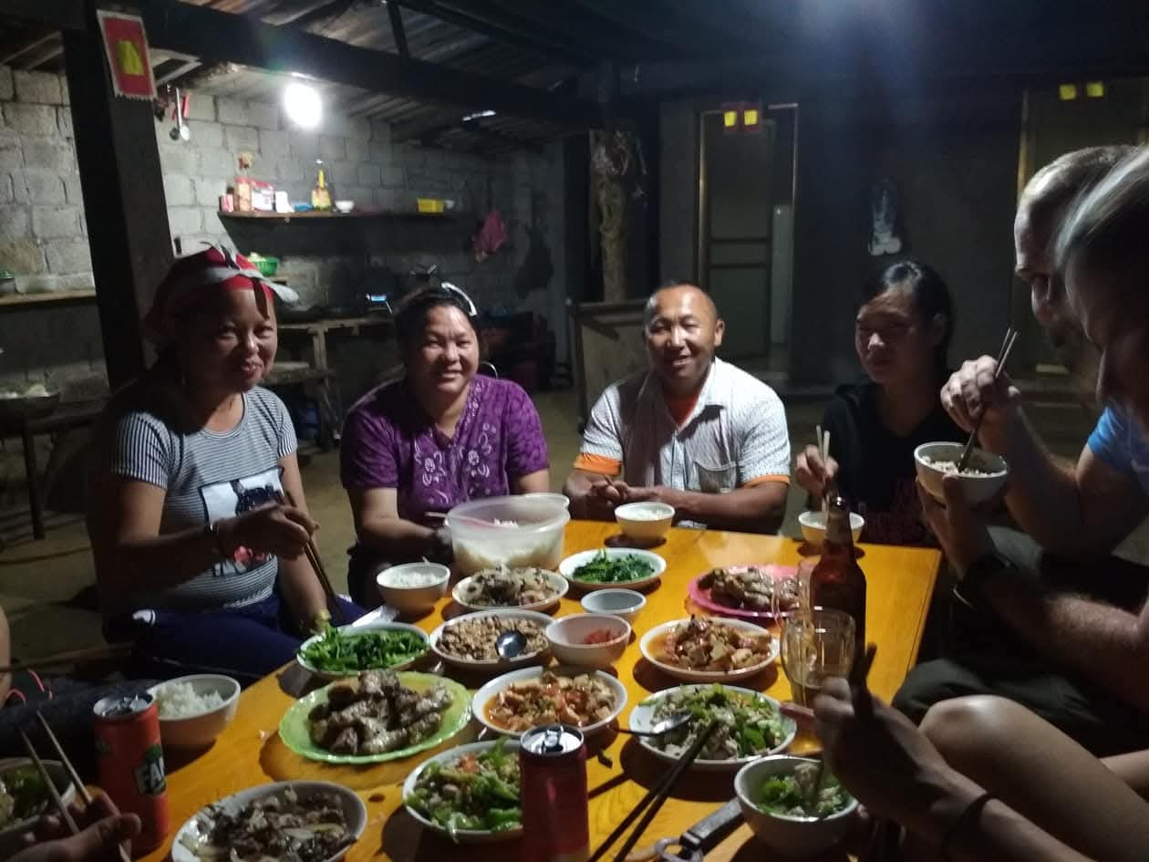 Dennis sharing an evening meal with a local family