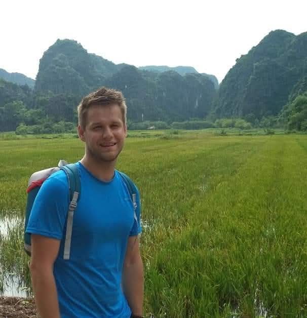 Dennis travelling through rice fields in Vietnam